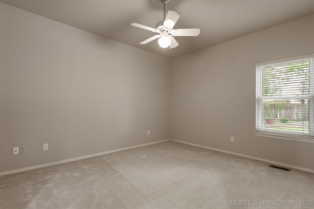 unfurnished room with visible vents, baseboards, ceiling fan, and light carpet