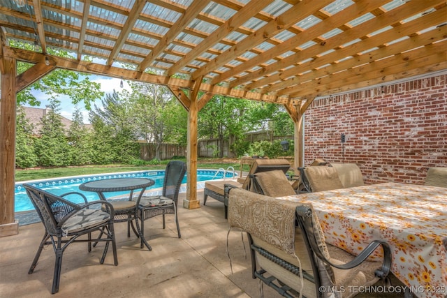 view of patio / terrace with a fenced in pool, a fenced backyard, a pergola, and outdoor dining area