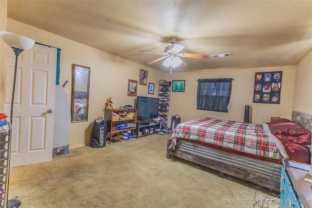 bedroom with carpet, visible vents, and a ceiling fan
