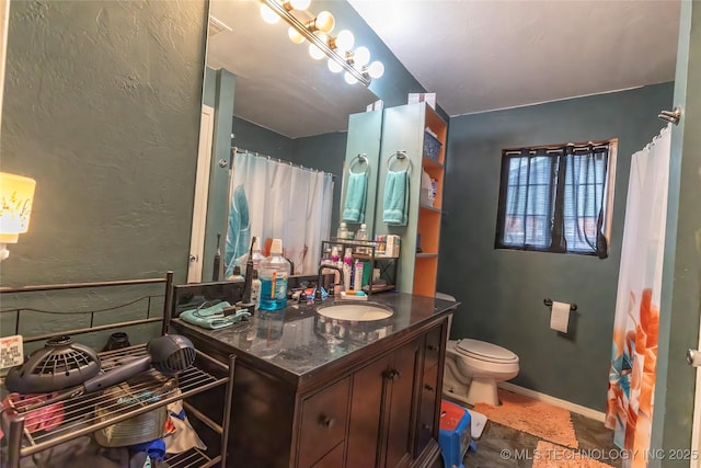 bathroom with toilet, vanity, and a shower with shower curtain