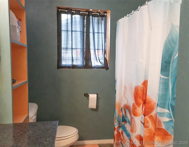bathroom with toilet, a healthy amount of sunlight, and a shower with shower curtain