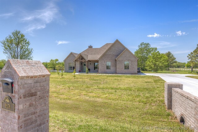 18576 N Jamestown Ave, Skiatook, OK 74070 - view of front of property with a chimney, a front yard, brick siding, and driveway