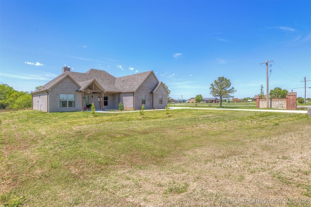 18576 N Jamestown Ave, Skiatook, OK 74070 - view of front facade featuring brick siding, a chimney, and a front yard