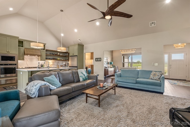 18576 N Jamestown Ave, Skiatook, OK 74070 - living area featuring light wood-style floors, visible vents, a ceiling fan, and high vaulted ceiling