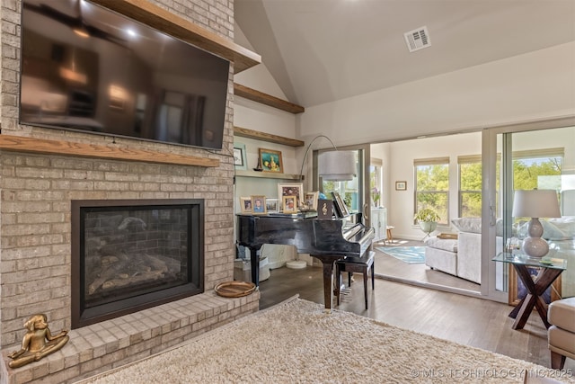 18576 N Jamestown Ave, Skiatook, OK 74070 - sitting room featuring high vaulted ceiling, a brick fireplace, visible vents, and wood finished floors
