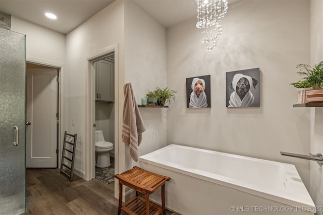 18576 N Jamestown Ave, Skiatook, OK 74070 - bathroom with toilet, a tub, and wood finished floors