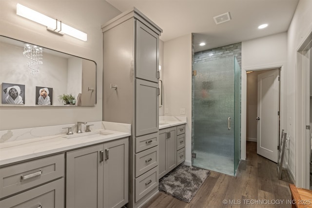 18576 N Jamestown Ave, Skiatook, OK 74070 - bathroom with vanity, visible vents, wood finished floors, and a shower stall