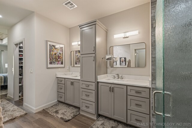 18576 N Jamestown Ave, Skiatook, OK 74070 - full bath featuring wood finished floors, a stall shower, visible vents, baseboards, and vanity