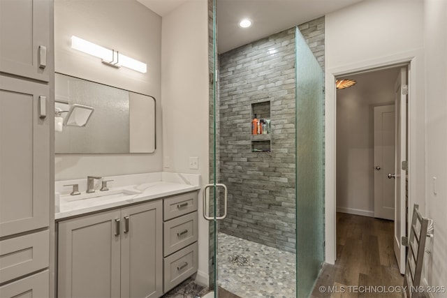 18576 N Jamestown Ave, Skiatook, OK 74070 - bathroom featuring vanity, baseboards, wood finished floors, and a shower stall