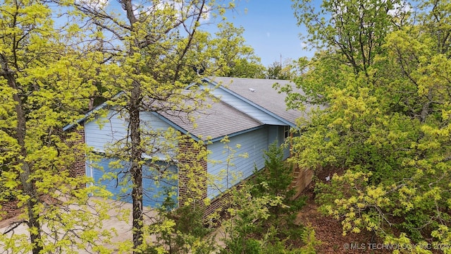857 Bayshore Dr, Sand Springs, OK 74063 - view of home's exterior with a shingled roof