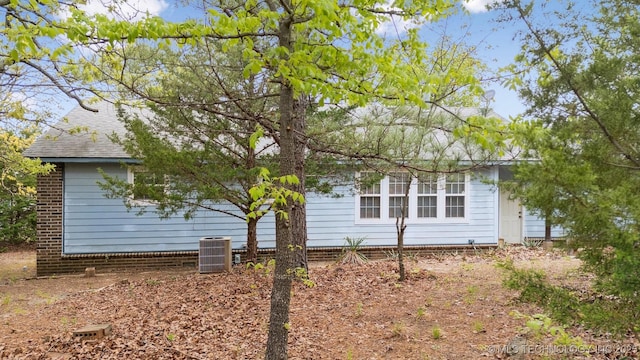 857 Bayshore Dr, Sand Springs, OK 74063 - view of property exterior with central air condition unit and a shingled roof