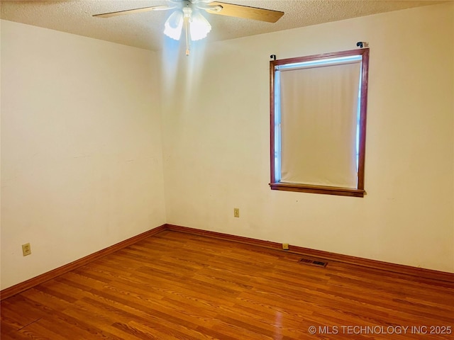 109 Ash Ave, Fort Gibson, OK 74434 - unfurnished room featuring a textured ceiling, visible vents, baseboards, a ceiling fan, and wood finished floors