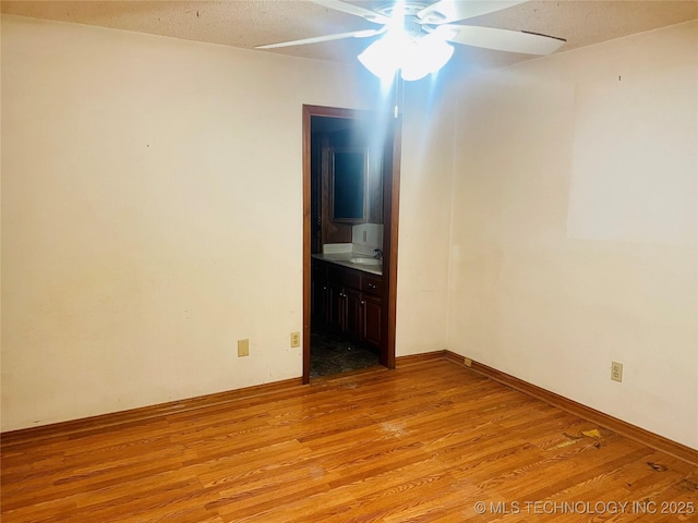 109 Ash Ave, Fort Gibson, OK 74434 - empty room featuring a ceiling fan, a sink, a textured ceiling, and light wood-style flooring
