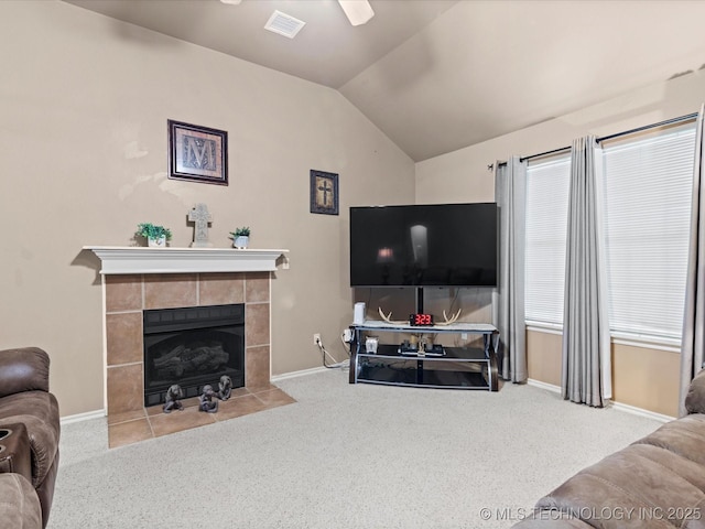 living room with carpet flooring, visible vents, and vaulted ceiling
