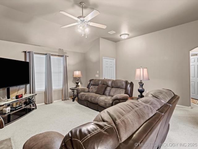 living area with baseboards, visible vents, ceiling fan, and light colored carpet