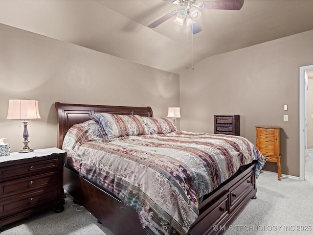 bedroom featuring ceiling fan, vaulted ceiling, and light colored carpet