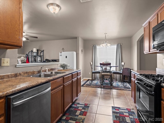 kitchen with black appliances, light tile patterned floors, brown cabinets, and a sink