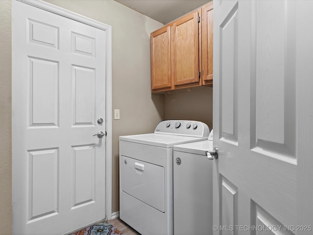 washroom with cabinet space and washing machine and clothes dryer