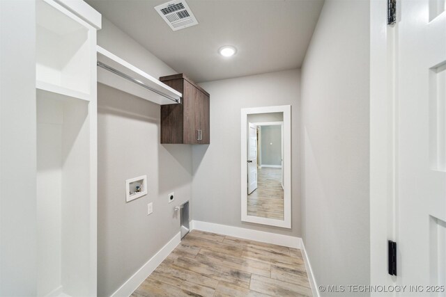 919 E 11th St, Claremore, OK 74017 - washroom with hookup for an electric dryer, washer hookup, baseboards, light wood-style floors, and recessed lighting