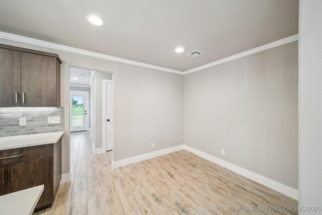 919 E 11th St, Claremore, OK 74017 - unfurnished dining area with ornamental molding, baseboards, light wood-style floors, and recessed lighting