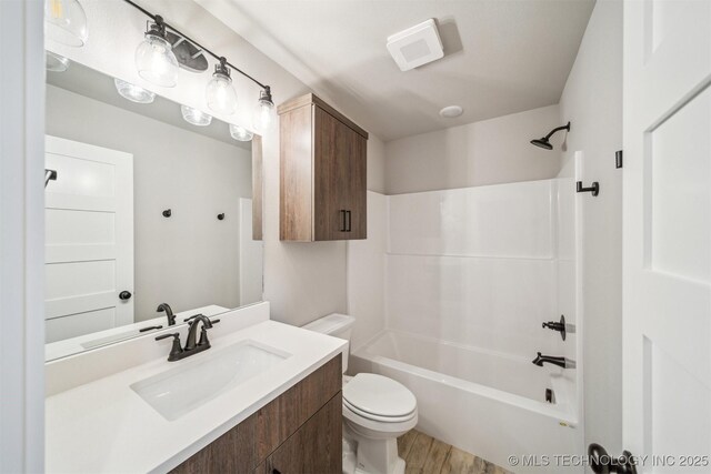 919 E 11th St, Claremore, OK 74017 - full bathroom featuring vanity, toilet, bathtub / shower combination, and wood finished floors
