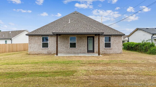 919 E 11th St, Claremore, OK 74017 - rear view of house featuring a shingled roof, a patio, and brick siding