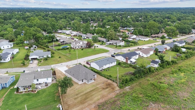 919 E 11th St, Claremore, OK 74017 - aerial perspective of suburban area with a heavily wooded area