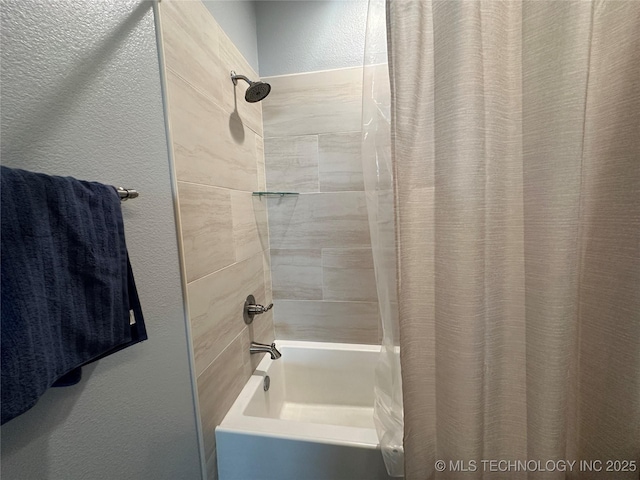 full bathroom featuring a textured wall and shower / bath combination with curtain