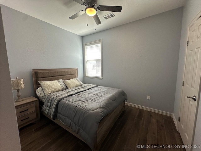 bedroom featuring ceiling fan, baseboards, dark wood-style flooring, and visible vents