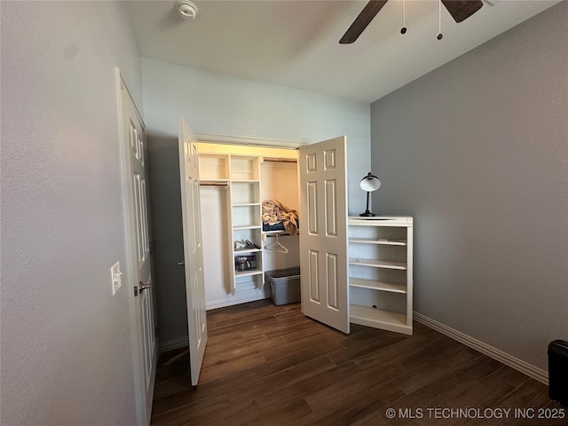 bedroom with dark wood finished floors, baseboards, ceiling fan, and a closet