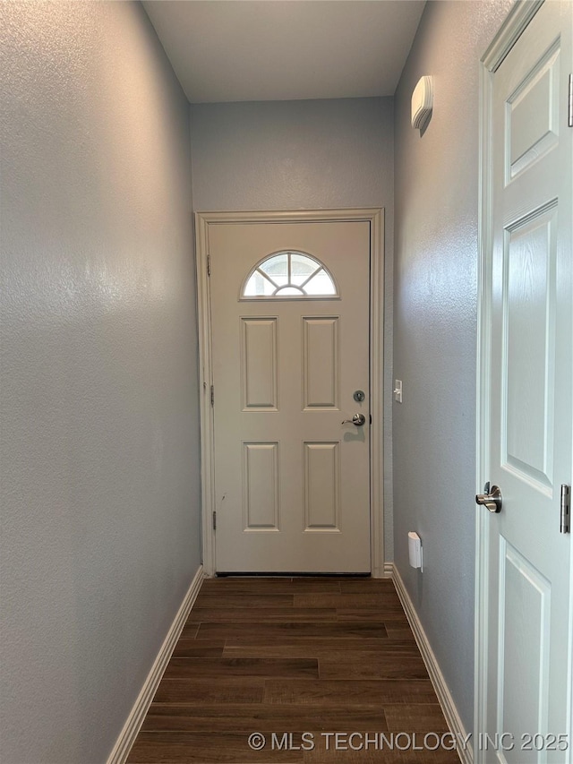 entryway with baseboards and dark wood-style floors