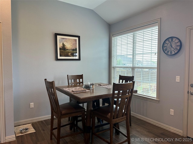 dining room featuring vaulted ceiling, baseboards, and dark wood-type flooring