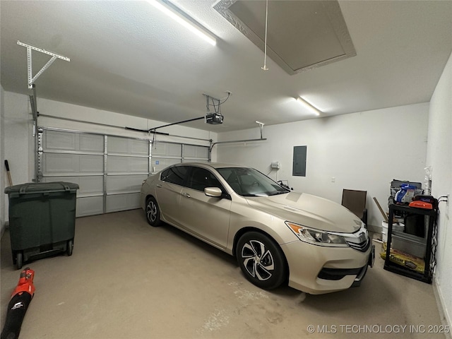 garage featuring electric panel and a garage door opener
