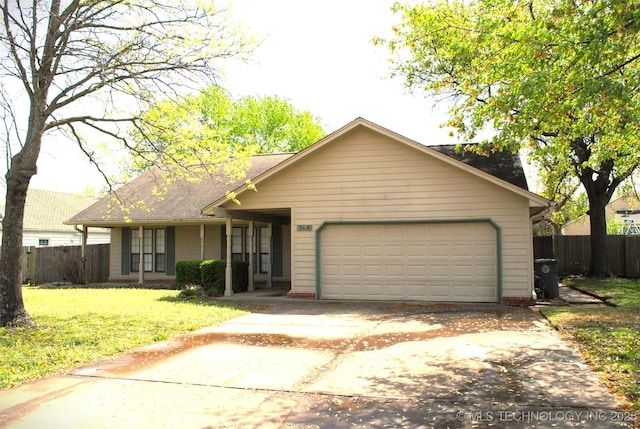 ranch-style house with an attached garage, fence, driveway, and a front lawn