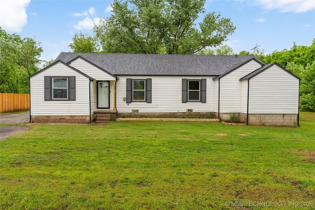 view of front facade with a shingled roof, crawl space, fence, and a front yard