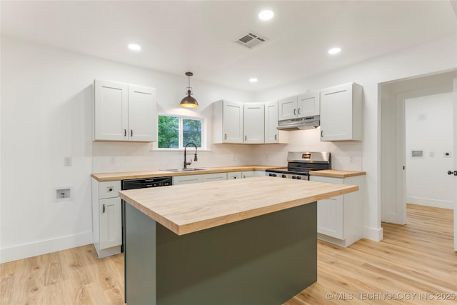kitchen with stainless steel range with electric stovetop, a sink, wood counters, under cabinet range hood, and light wood-style floors
