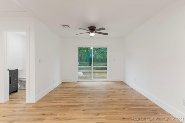 empty room featuring ceiling fan, light wood-style flooring, and baseboards