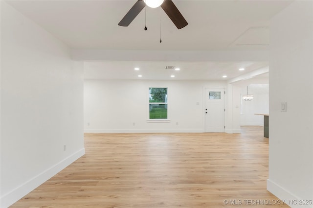 unfurnished room featuring baseboards, light wood-style flooring, ceiling fan with notable chandelier, and recessed lighting