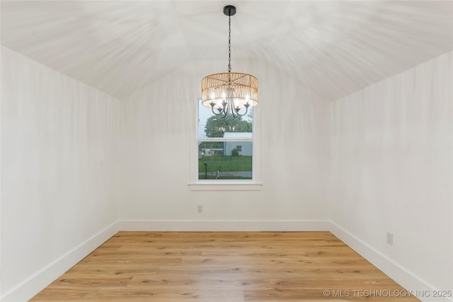 unfurnished dining area with an inviting chandelier, lofted ceiling, baseboards, and light wood finished floors