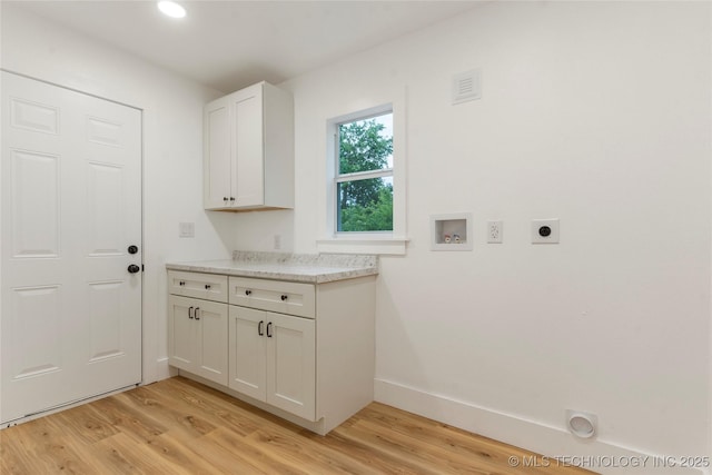 laundry area featuring light wood finished floors, baseboards, hookup for an electric dryer, and hookup for a washing machine