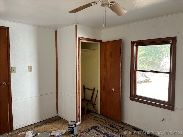 unfurnished bedroom with a closet and a ceiling fan