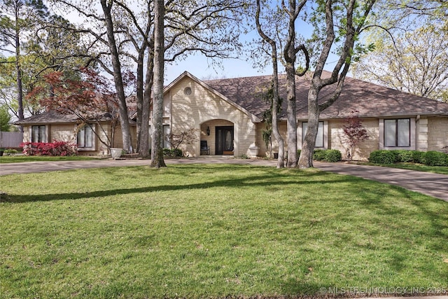 749 Brookhollow Ln, Bartlesville, OK 74006 - view of front of house with a front lawn, driveway, and a shingled roof