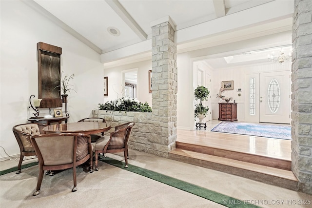 749 Brookhollow Ln, Bartlesville, OK 74006 - dining room featuring an inviting chandelier, carpet flooring, beam ceiling, and decorative columns