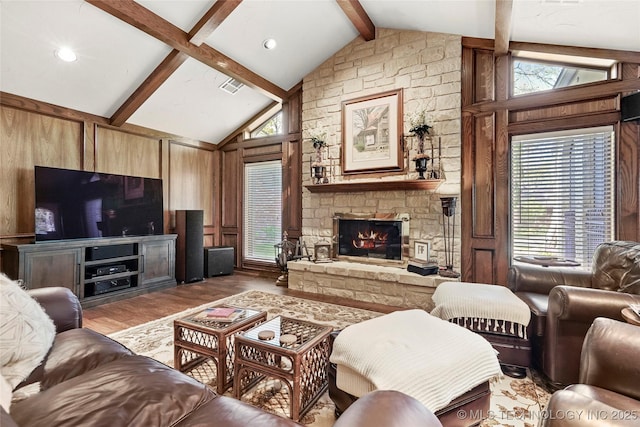 749 Brookhollow Ln, Bartlesville, OK 74006 - living area with recessed lighting, a stone fireplace, visible vents, wood finished floors, and lofted ceiling with beams
