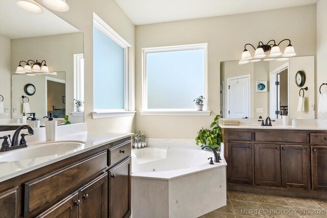 929 S 71st St, Broken Arrow, OK 74014 - bathroom featuring two vanities and a whirlpool tub