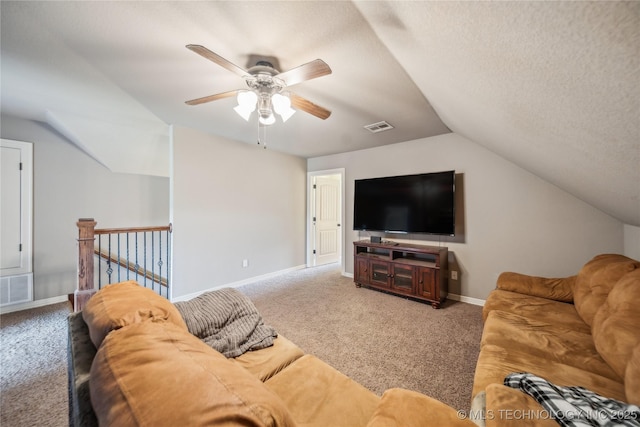 living area featuring vaulted ceiling, visible vents, carpet flooring, and a ceiling fan