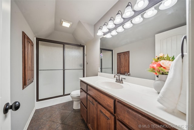 full bath featuring toilet, vaulted ceiling, baseboards, a shower stall, and vanity