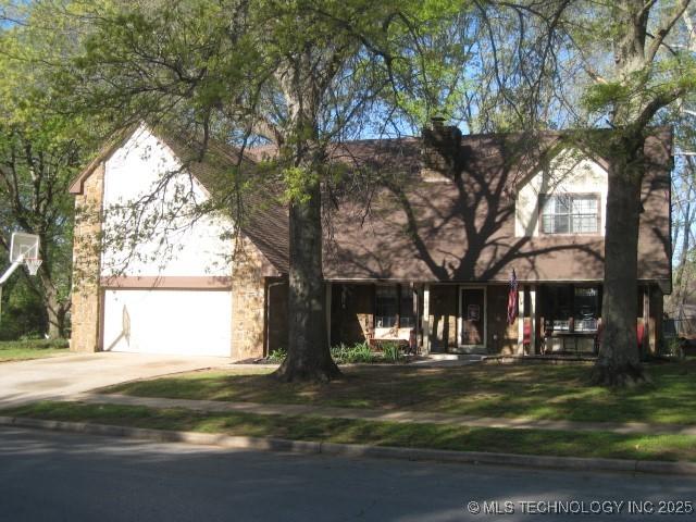 obstructed view of property featuring a garage and driveway