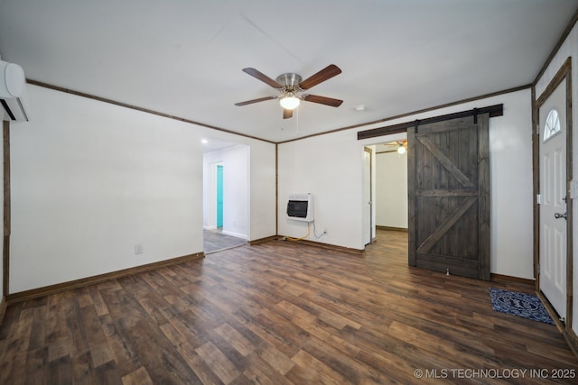 unfurnished living room with a barn door, dark wood finished floors, heating unit, baseboards, and ceiling fan