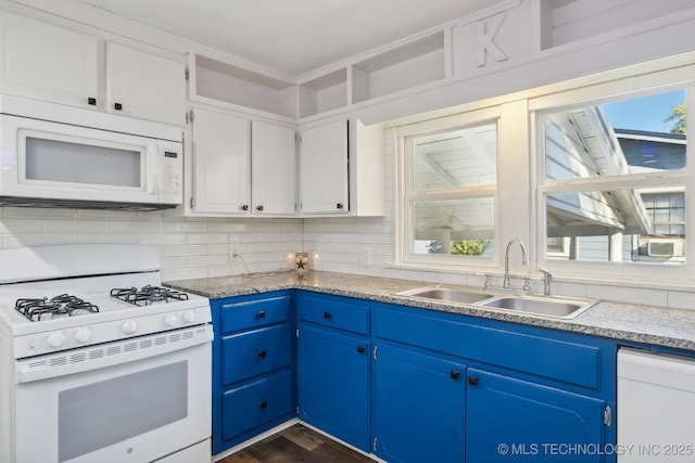 kitchen with blue cabinets, dark wood-style flooring, a sink, and white appliances